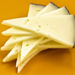 13781864 - some slices of manchego cheese, typical of spain, isolated on a white background